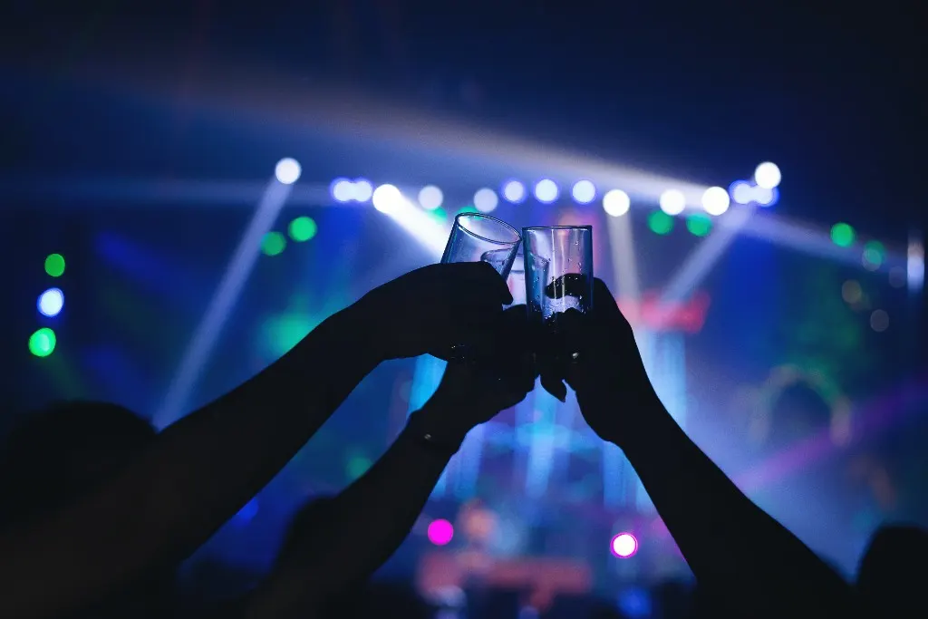 Friends toasting with drinks in a modern nightlife venue